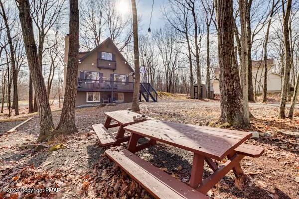 a wooden bench sitting in front of a house