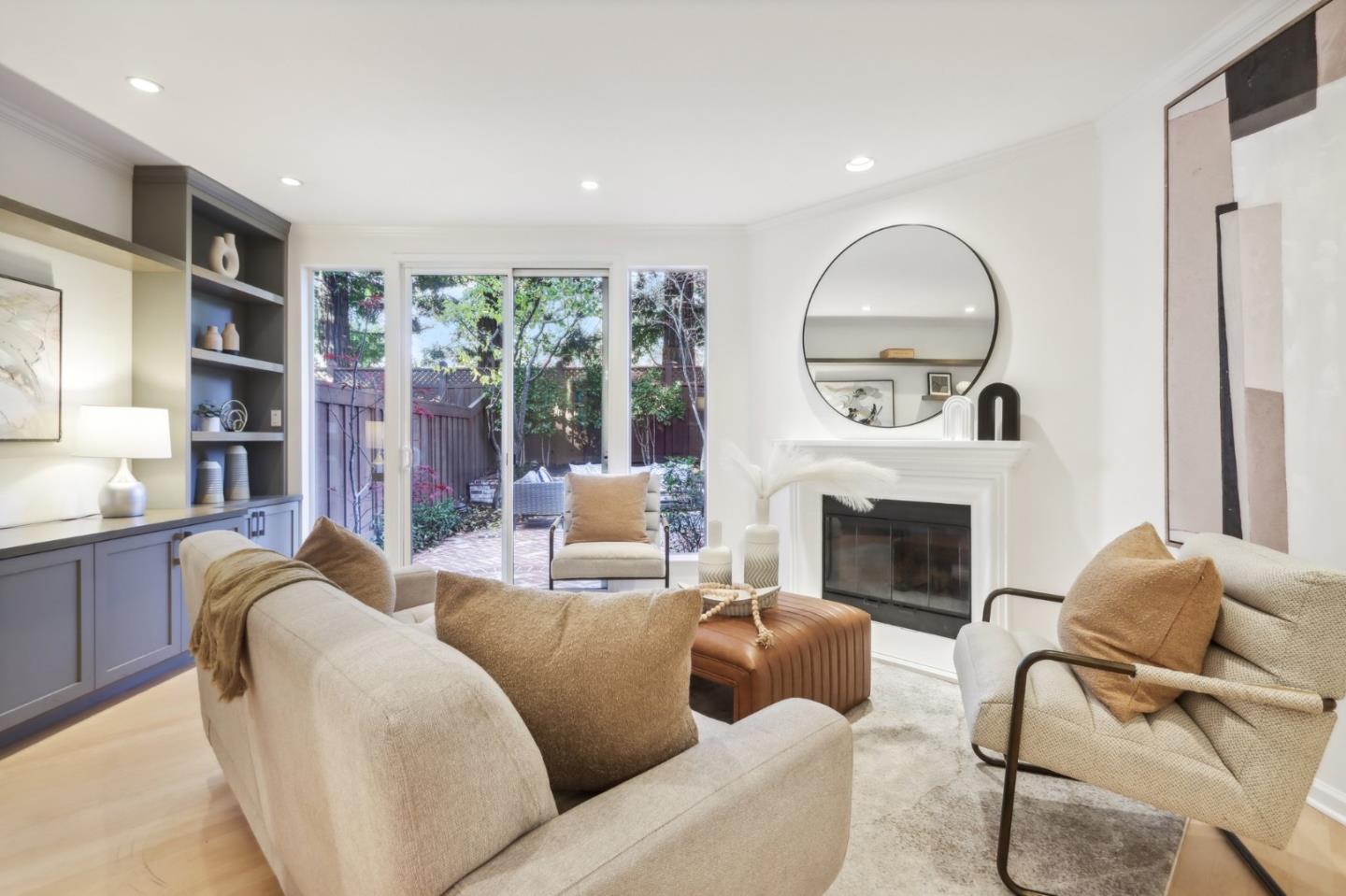 a living room with furniture fireplace and a large window