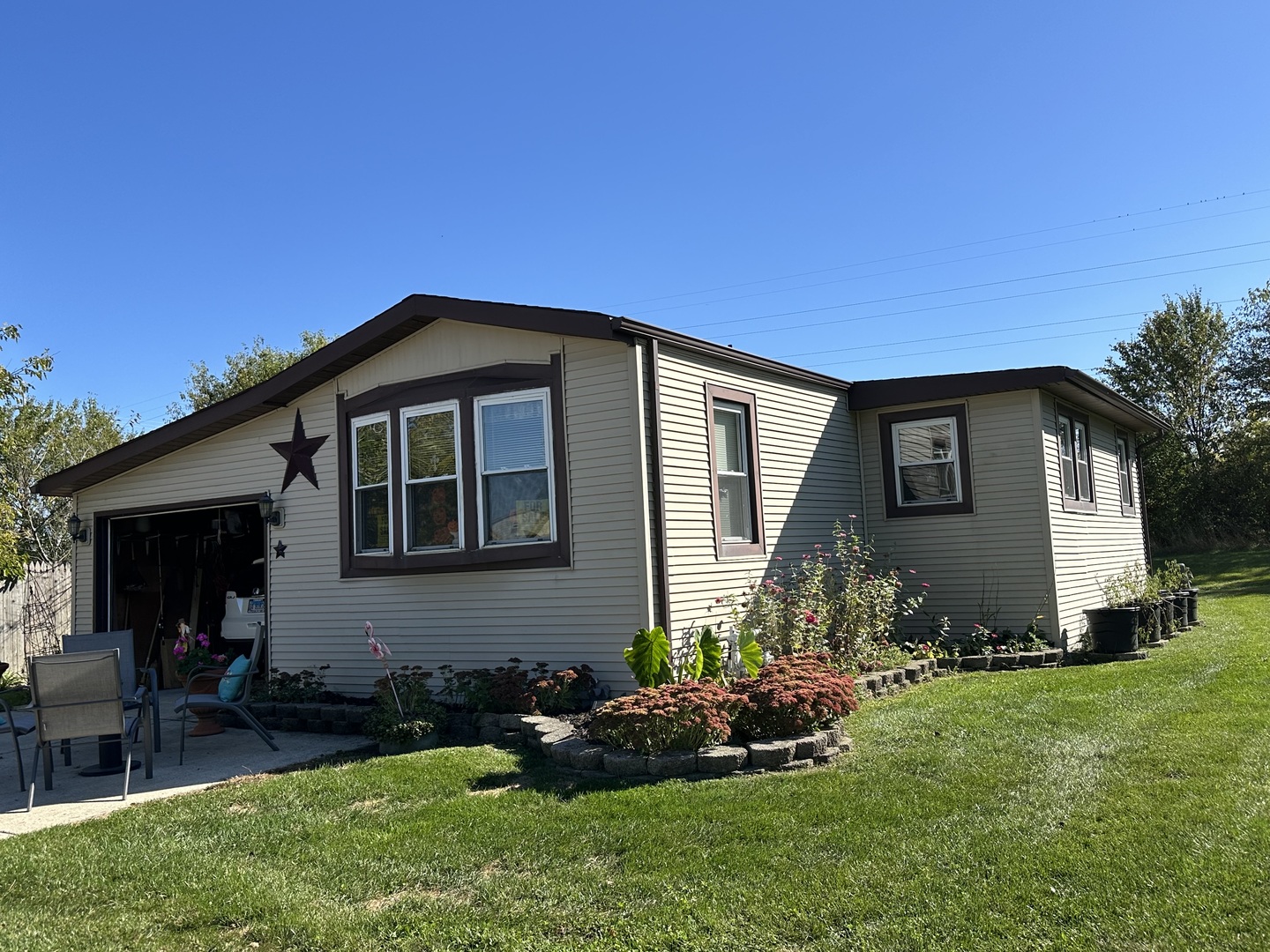 a front view of house with yard and outdoor seating