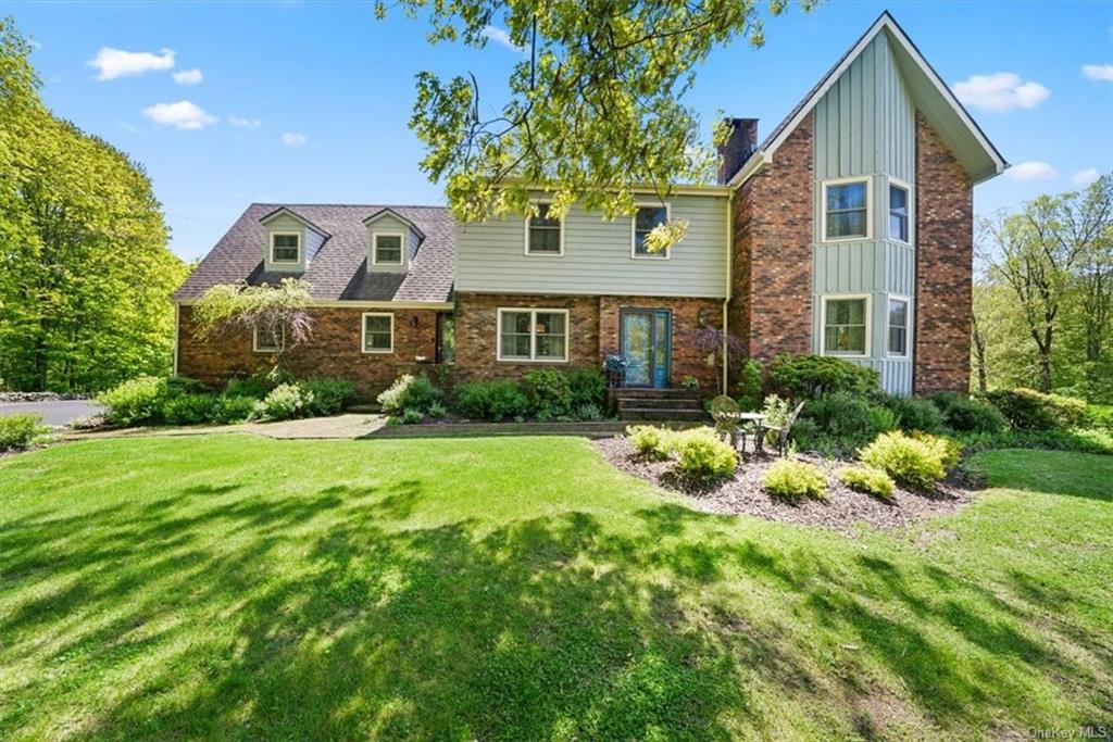 a front view of house with yard and green space