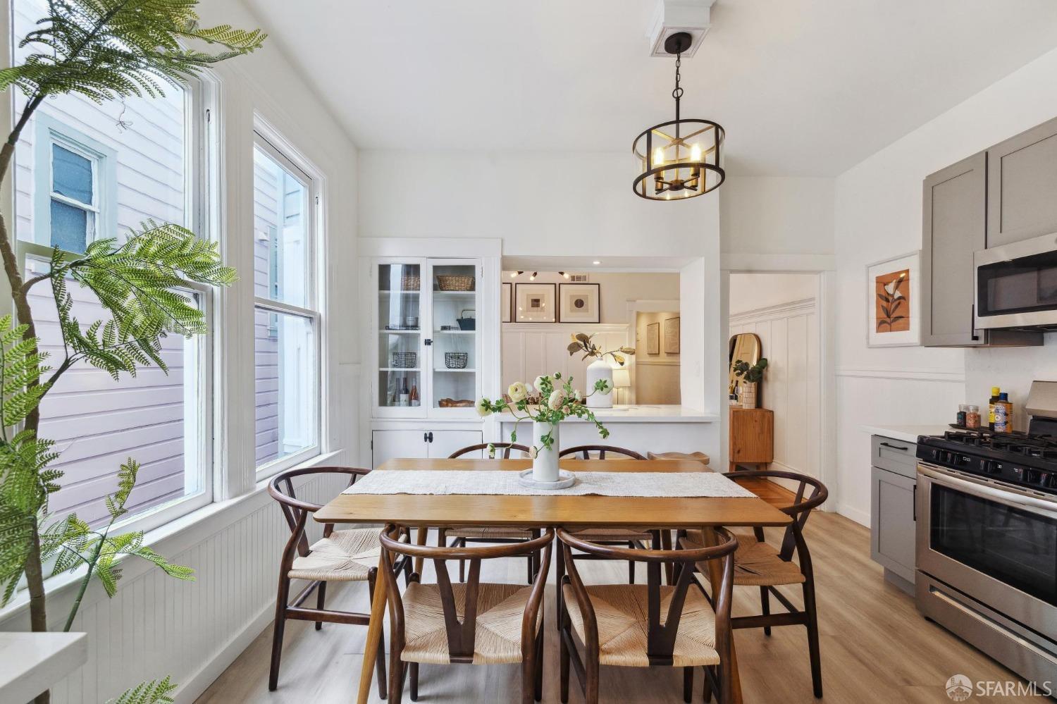 a view of a dining room with furniture window and wooden floor