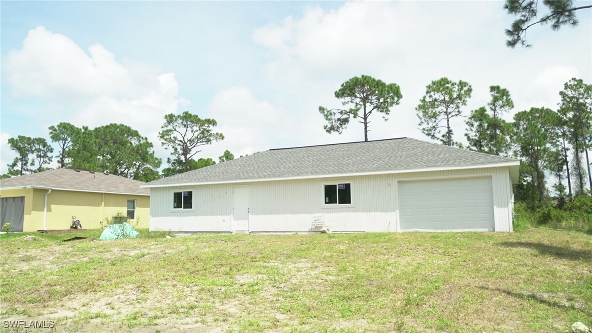 a view of a house with a backyard