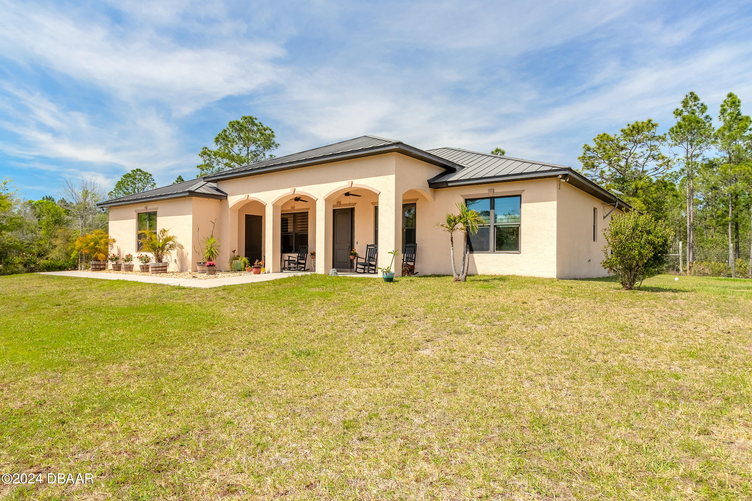 a front view of house with yard and green space