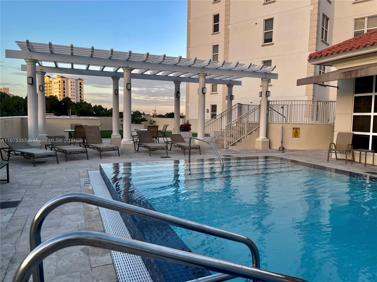 a view of swimming pool with outdoor seating