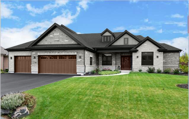 a front view of a house with a garden and yard