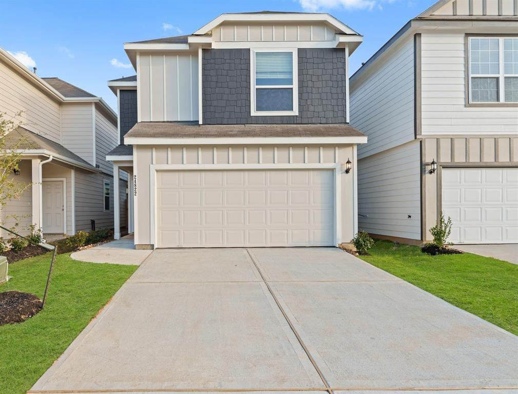 a view of a house with yard and a garage