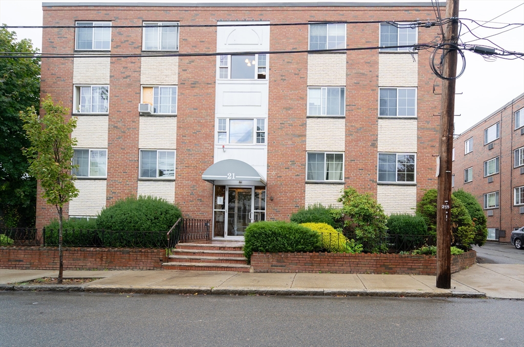 a view of a brick building next to a road