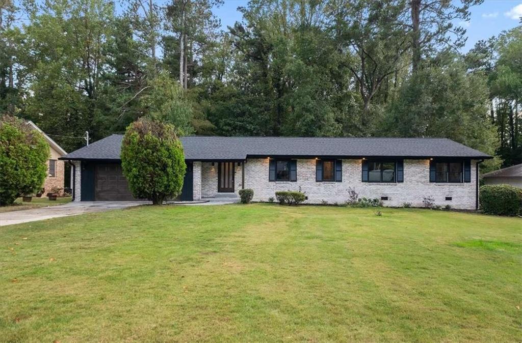 a front view of a house with a garden