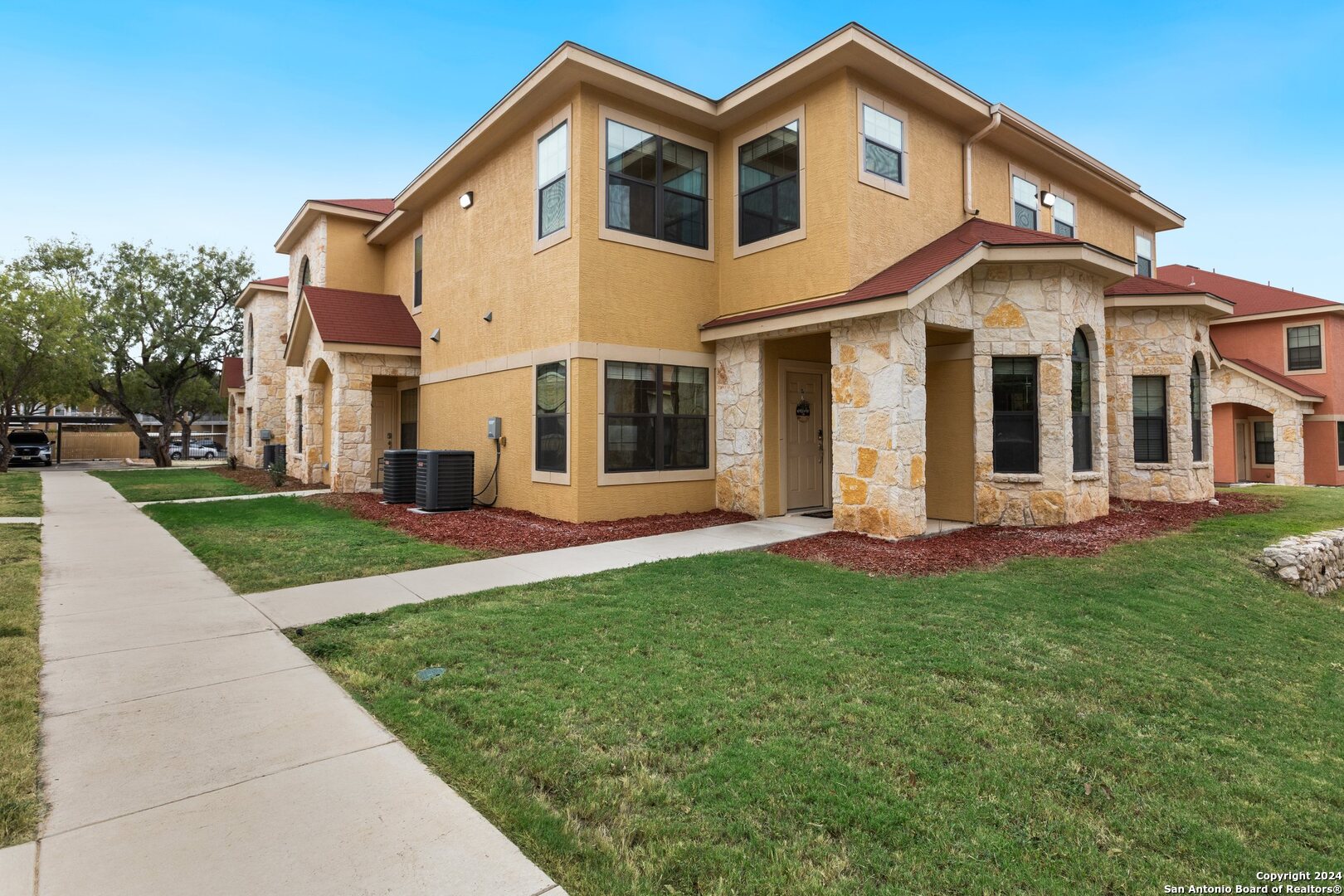 a front view of a house with a yard