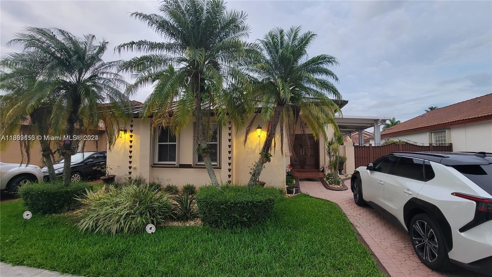 a house with palm tree in front of it