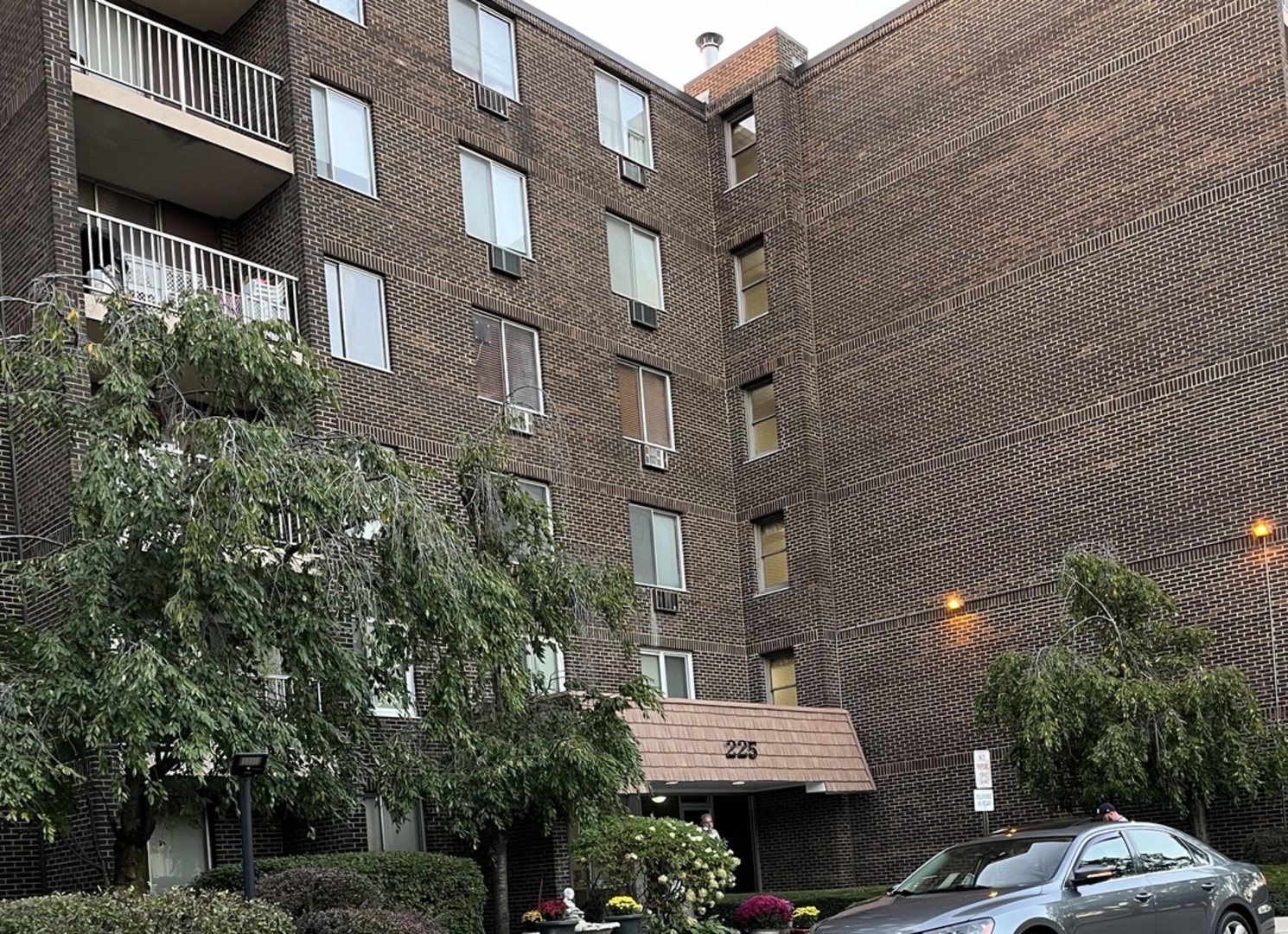 a car parked in front of a brick building