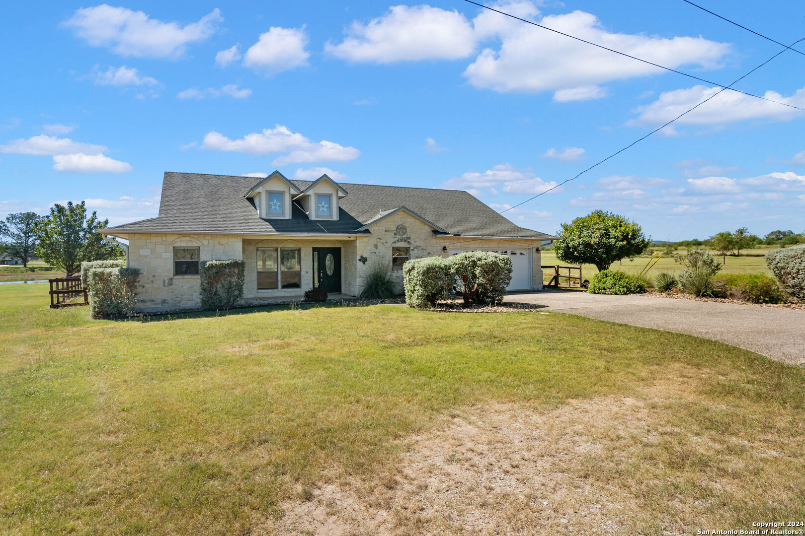 a front view of a house with a garden