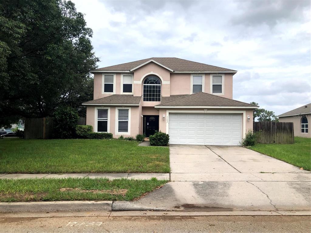 a view of a yard in front view of a house