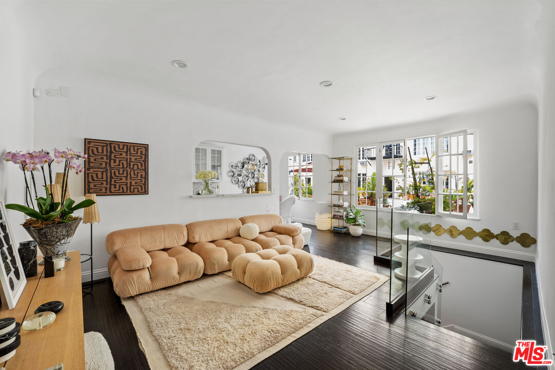 a living room with furniture rug and window