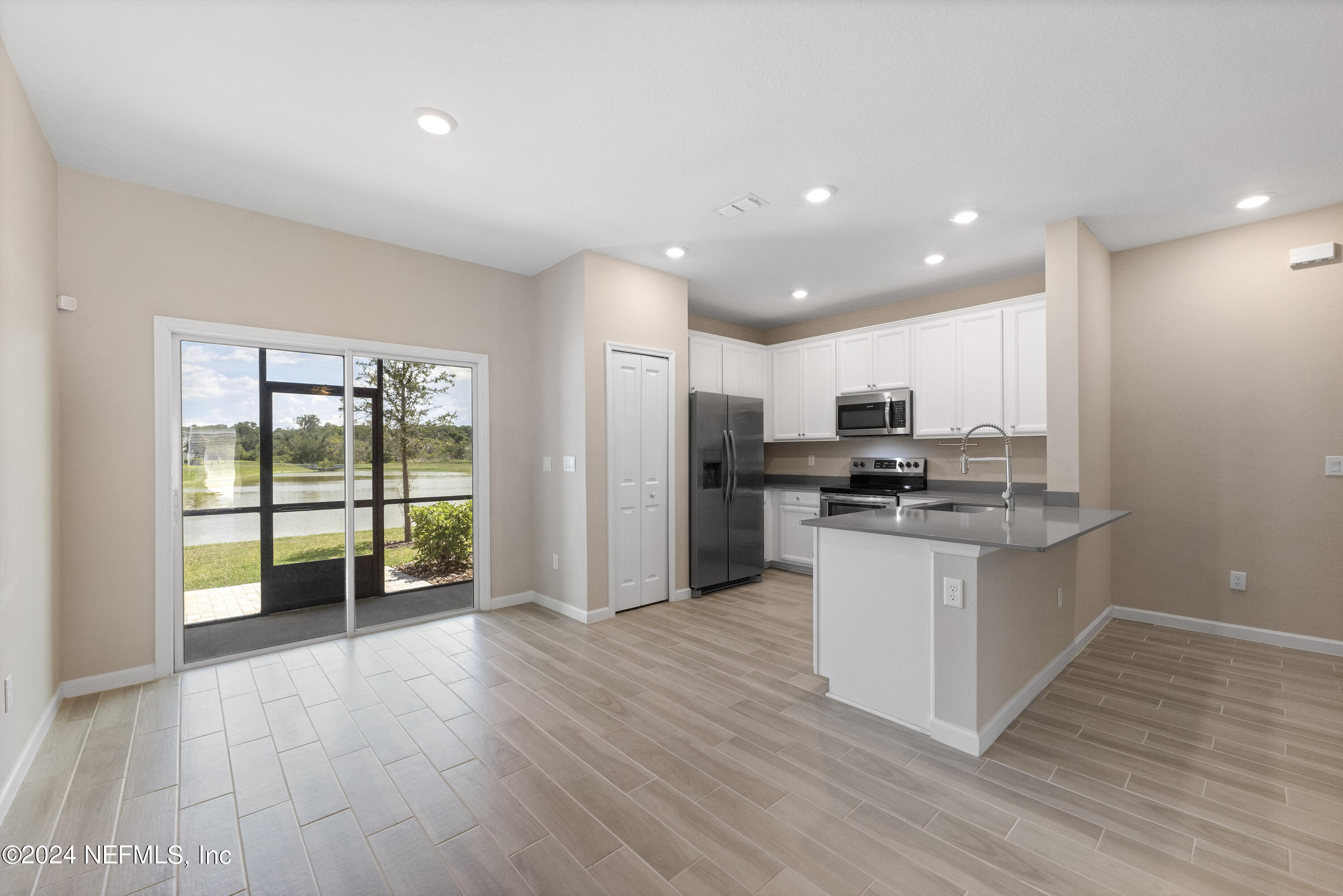 a kitchen with stainless steel appliances granite countertop a refrigerator and a sink