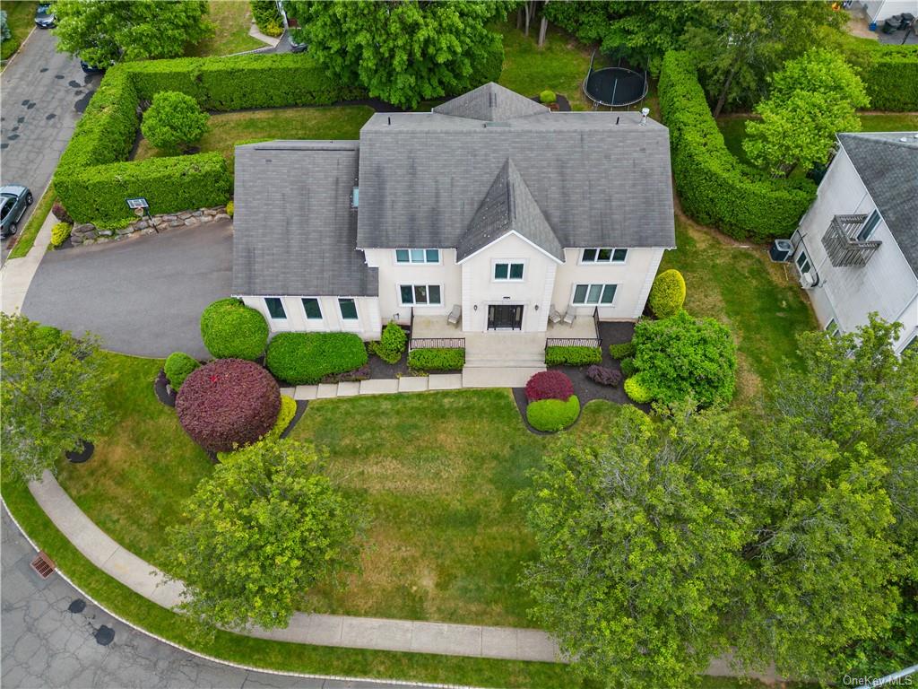 an aerial view of a house with swimming pool and outdoor seating