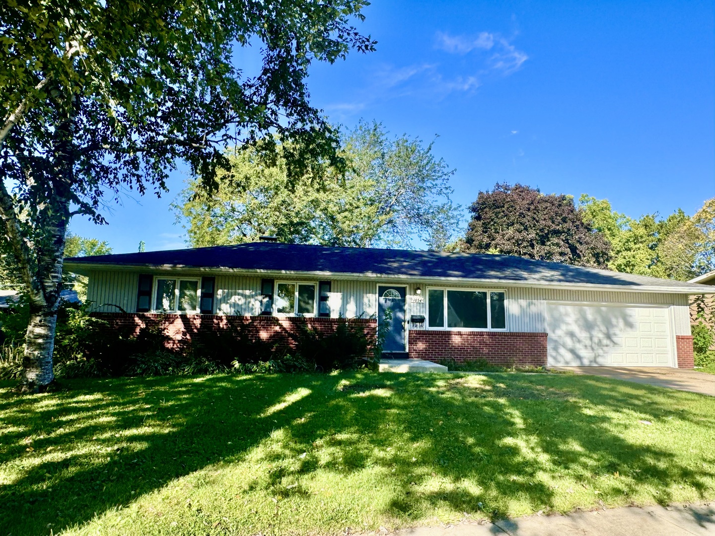 a view of house with backyard space and garden