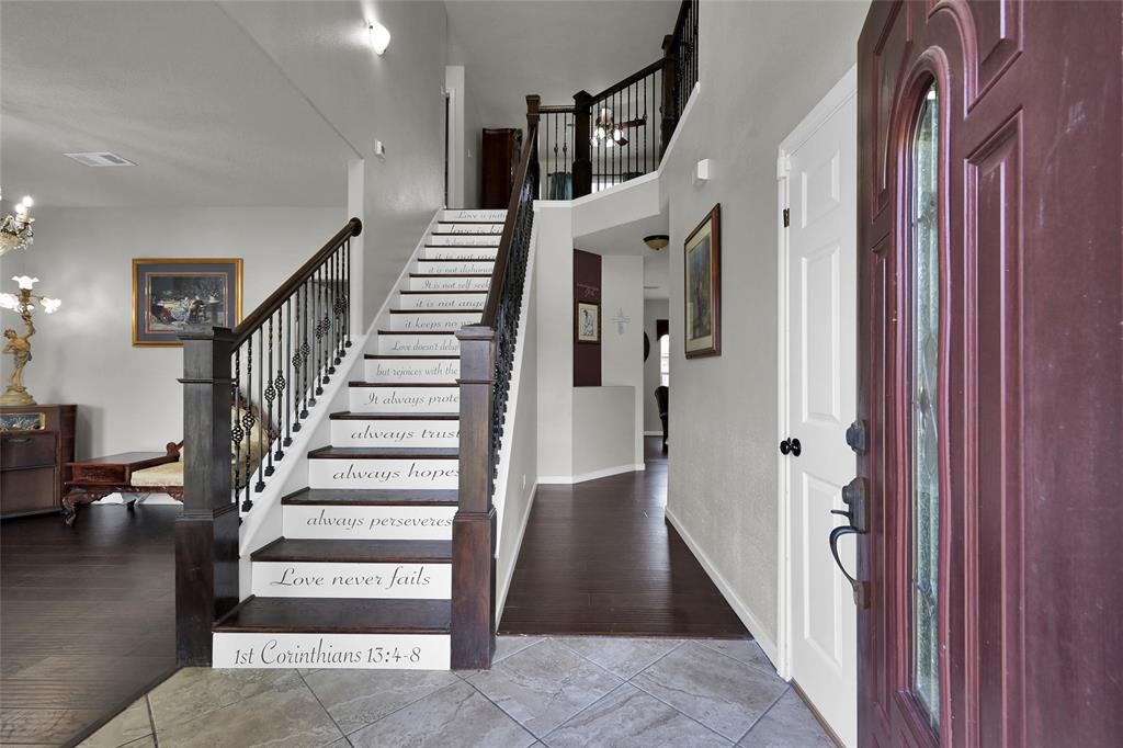 a view of entryway and hall with wooden floor