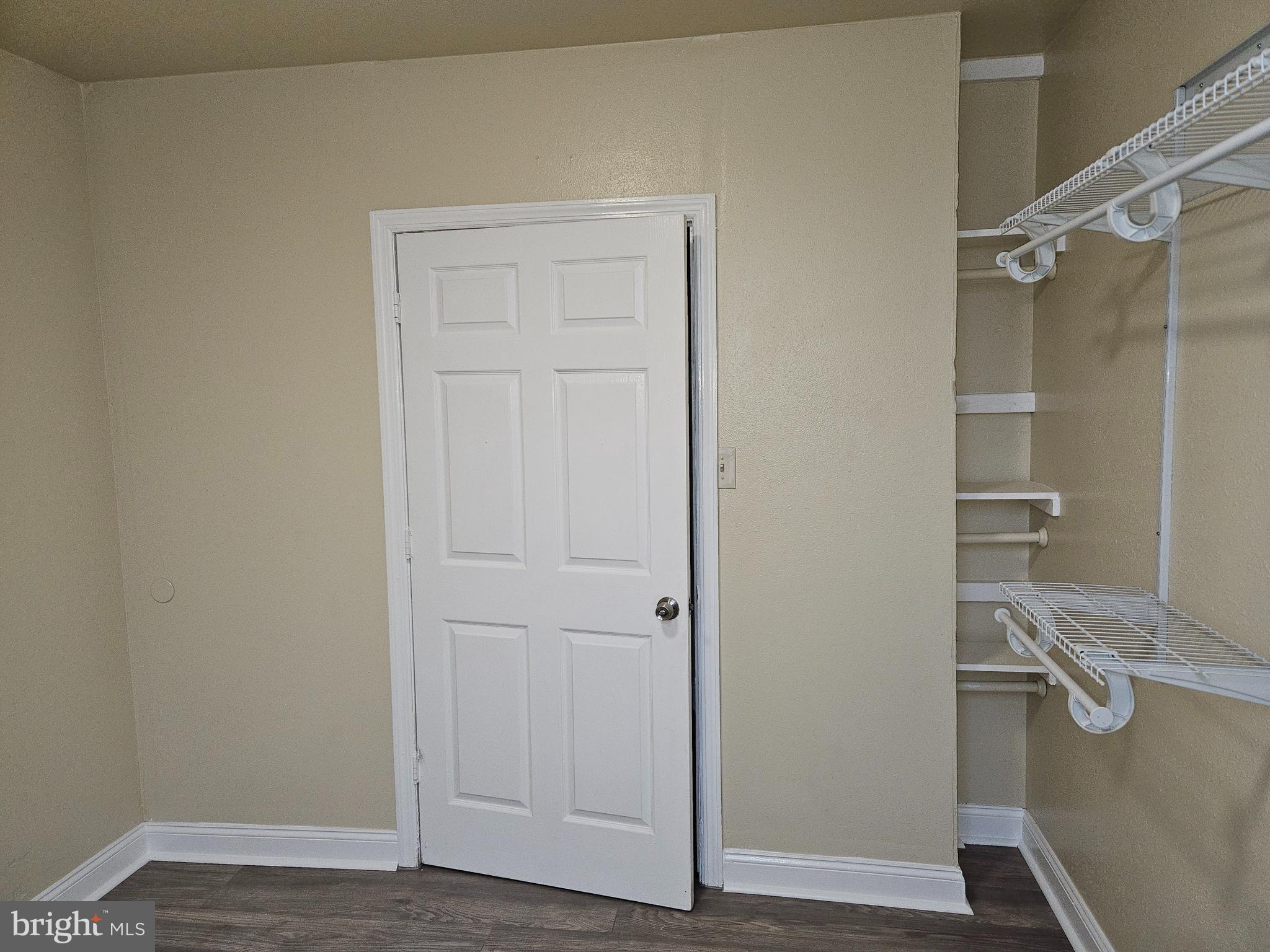 a view of walk in closet with empty racks