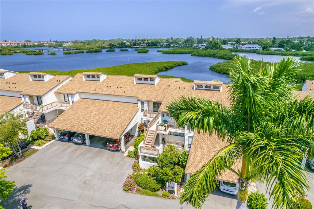 an aerial view of a house with outdoor space and lake view