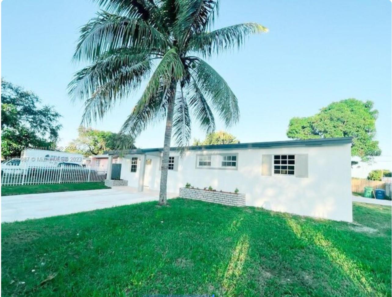 a view of house with backyard and swimming pool