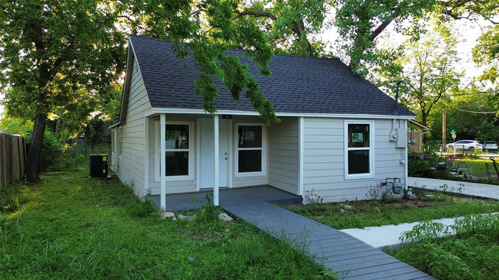 a front view of a house with a garden and yard