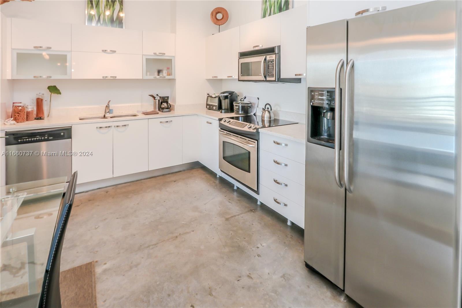 a kitchen with white cabinets and white appliances