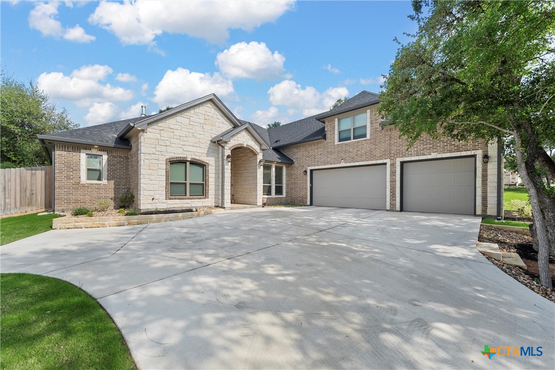 a view of a house with a backyard and a garage