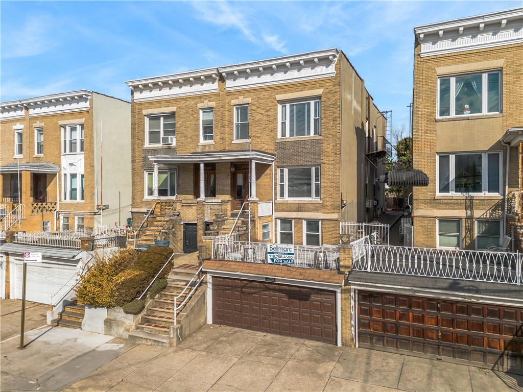 a front view of a residential apartment building with a yard