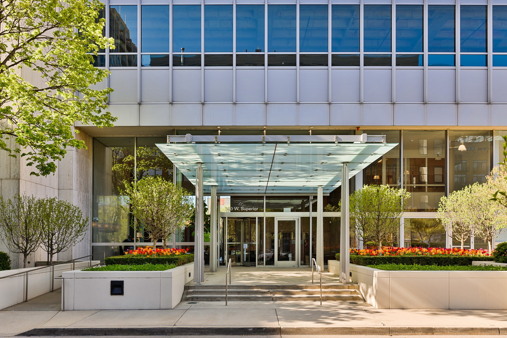 a front view of a building with plants