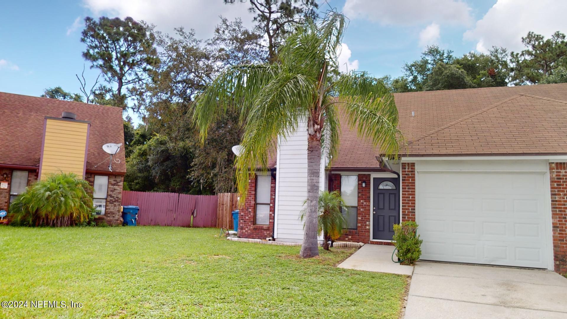 a front view of house with yard and green space