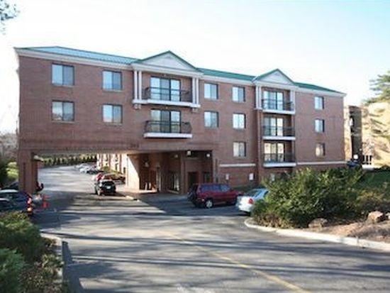 a front view of a building and car parked