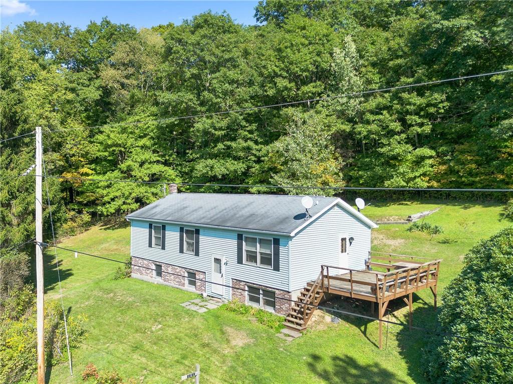 a aerial view of a house with swimming pool next to a big yard