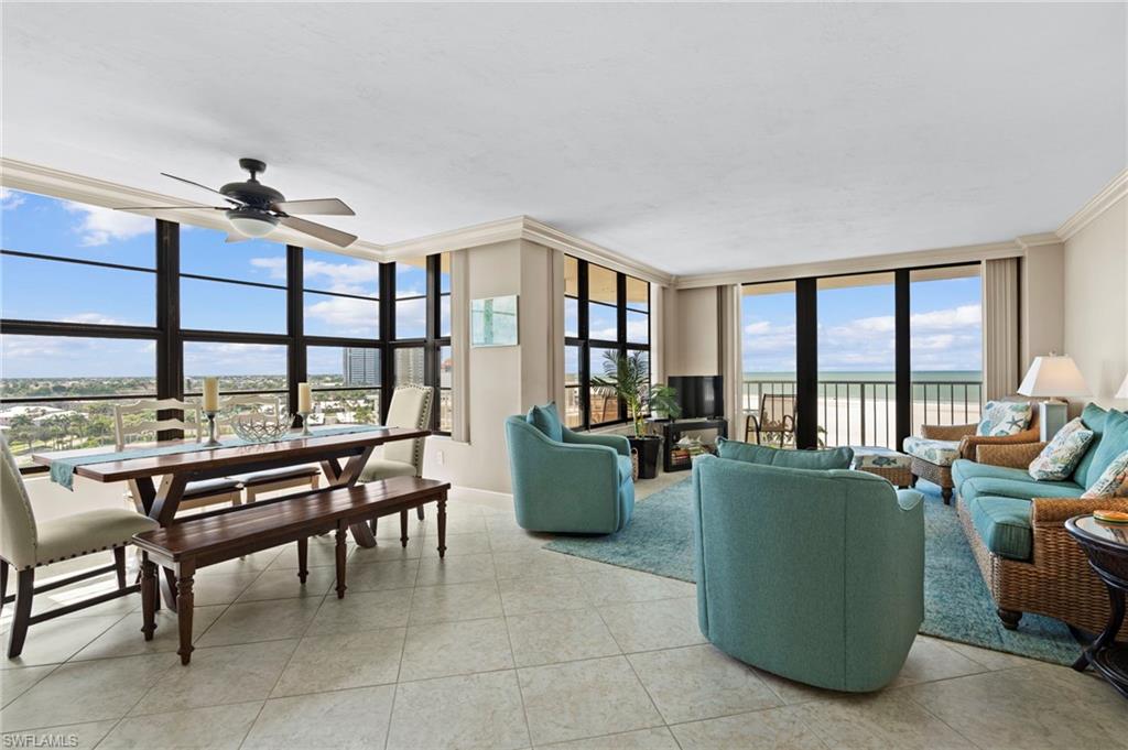 a living room with furniture and a floor to ceiling window