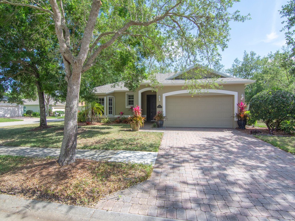 a front view of a house with a yard and trees