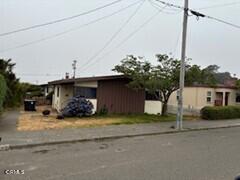 a view of a house with a patio and a yard