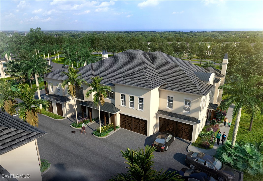 an aerial view of a house with a yard and lake view