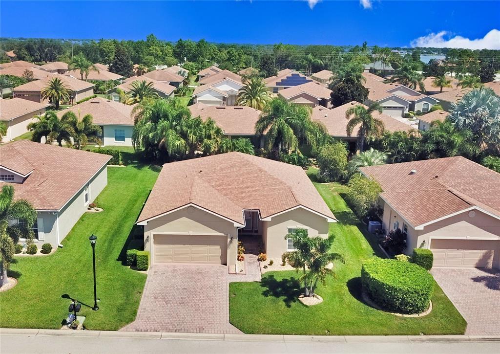 an aerial view of a house with a garden and trees