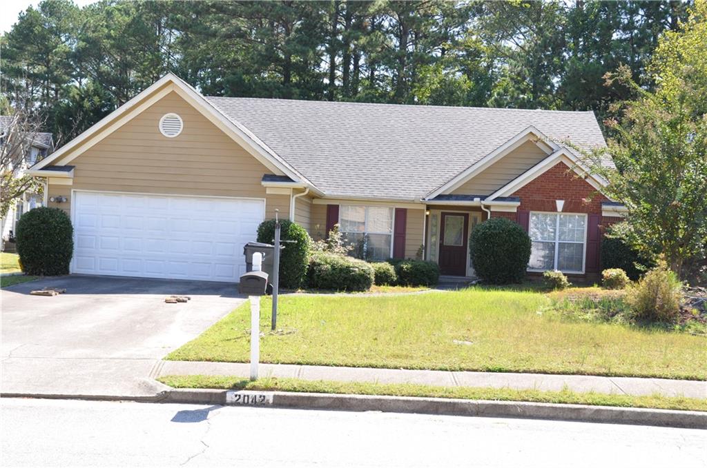 a front view of a house with a yard