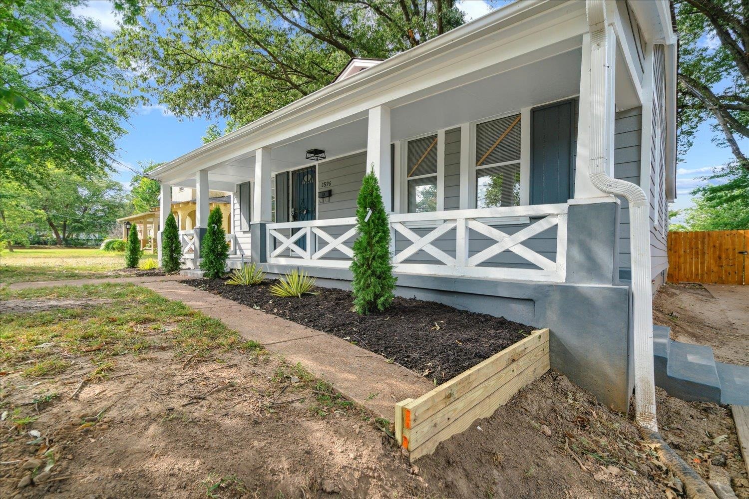 a view of a house with backyard and porch