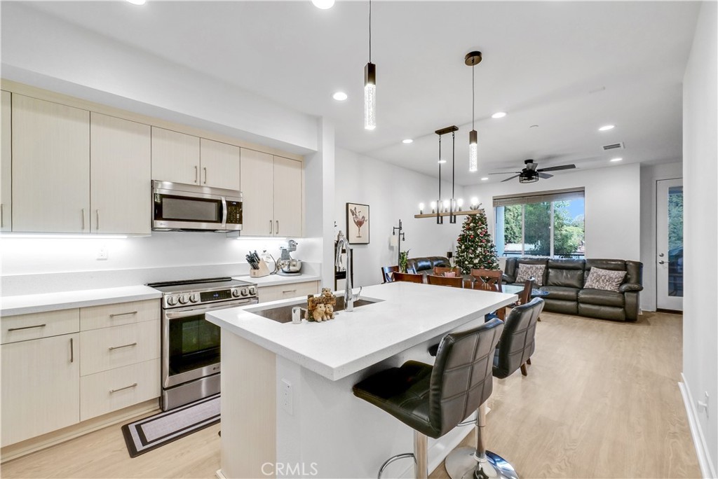 a kitchen with a stove a sink and a refrigerator