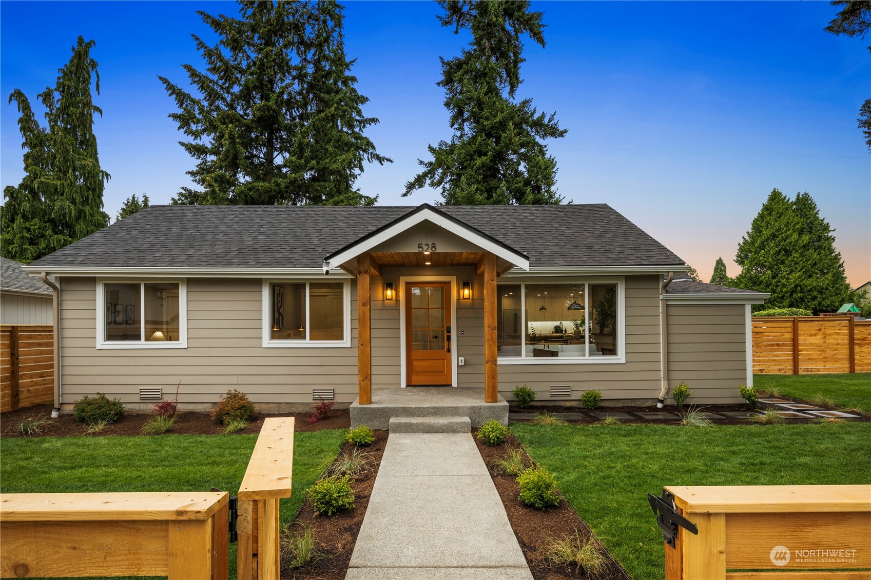 a front view of a house with yard and green space