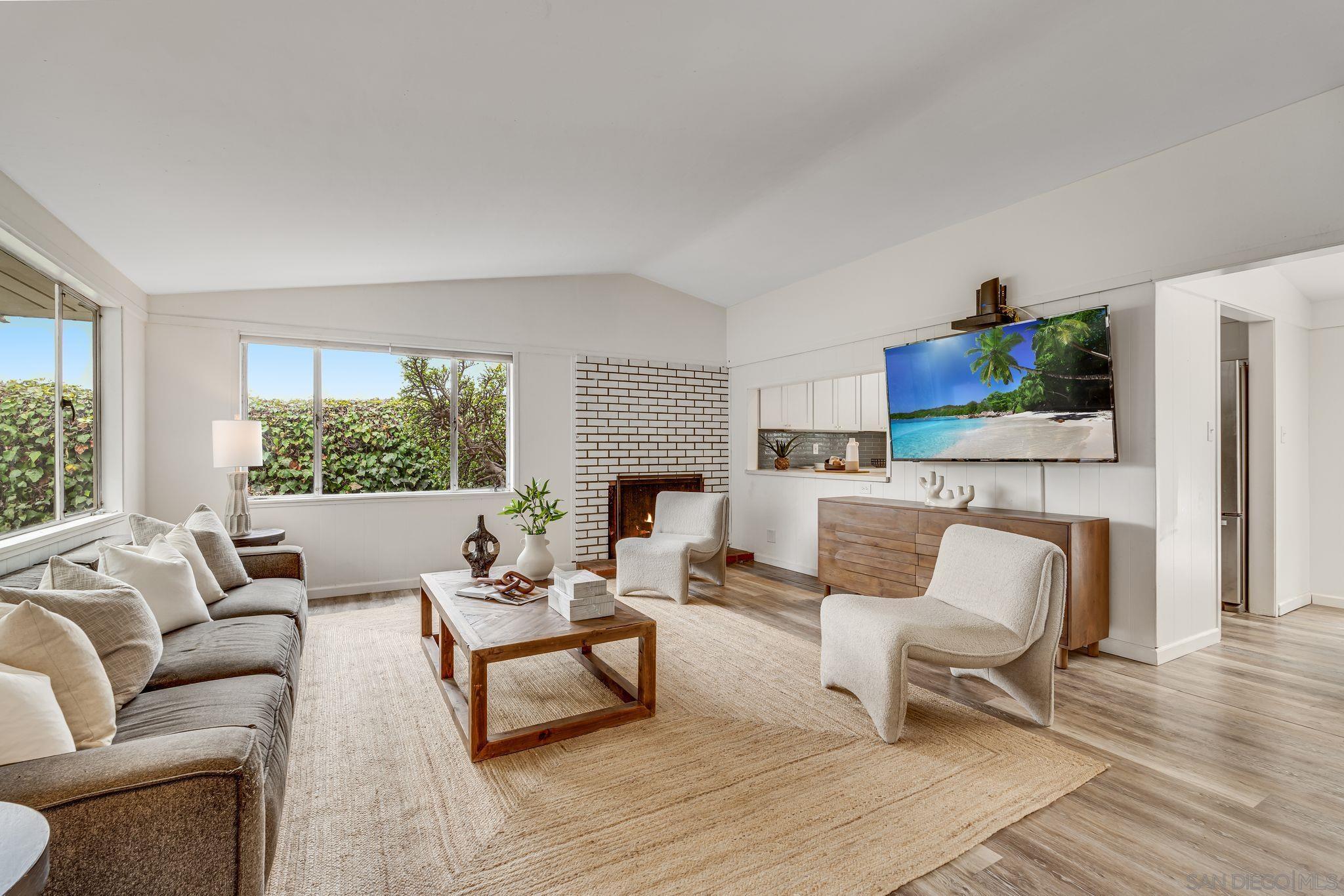 a living room with furniture fireplace and window