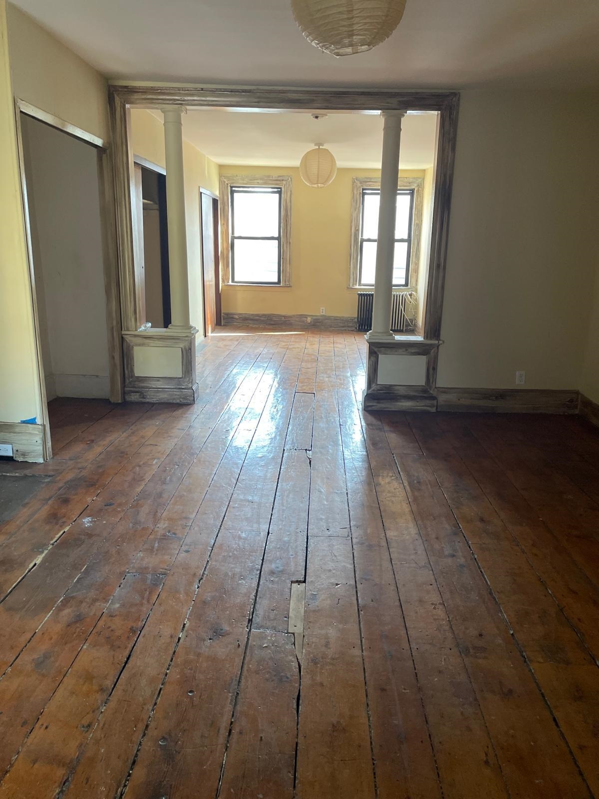 a view of a room with wooden floor and stairs