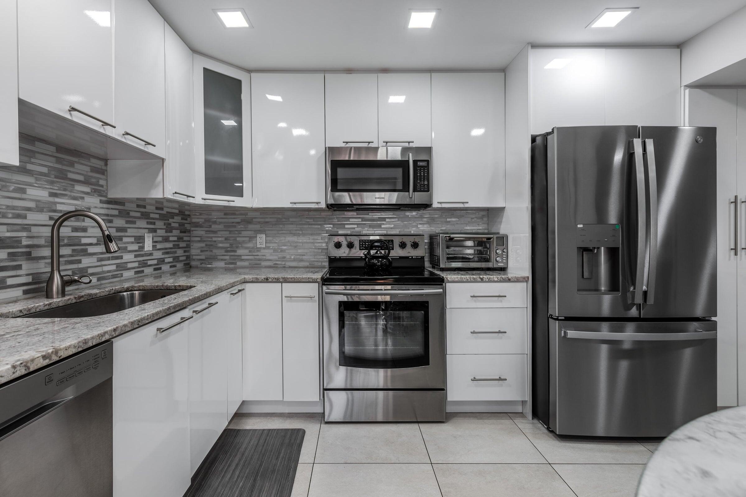 a kitchen with a sink stainless steel appliances and cabinets