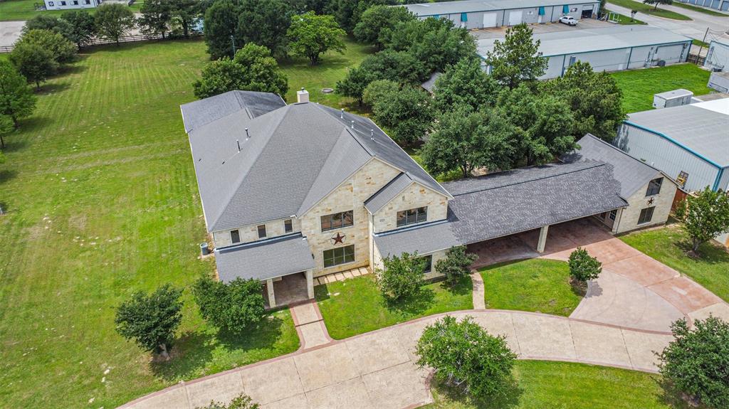 an aerial view of a house with a garden and lake view