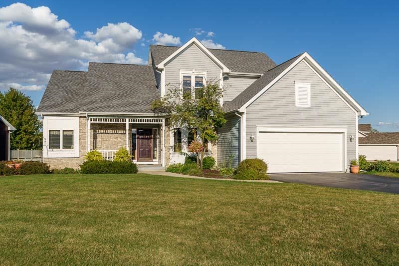 a front view of a house with a yard and garage