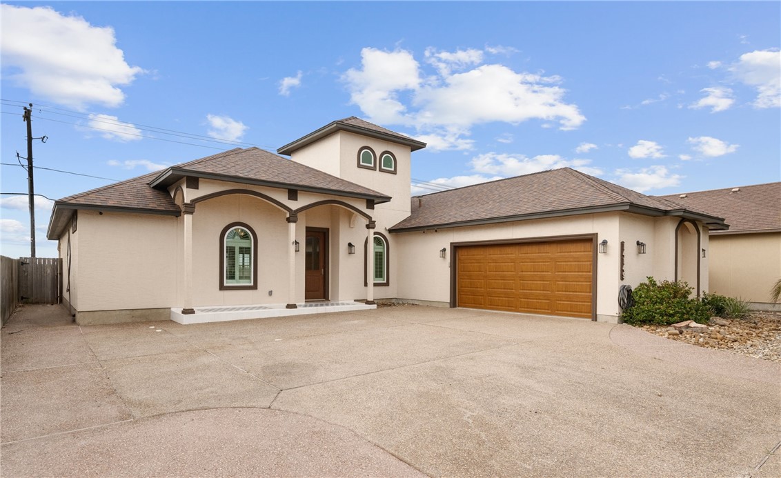 a view of a house with a yard and garage