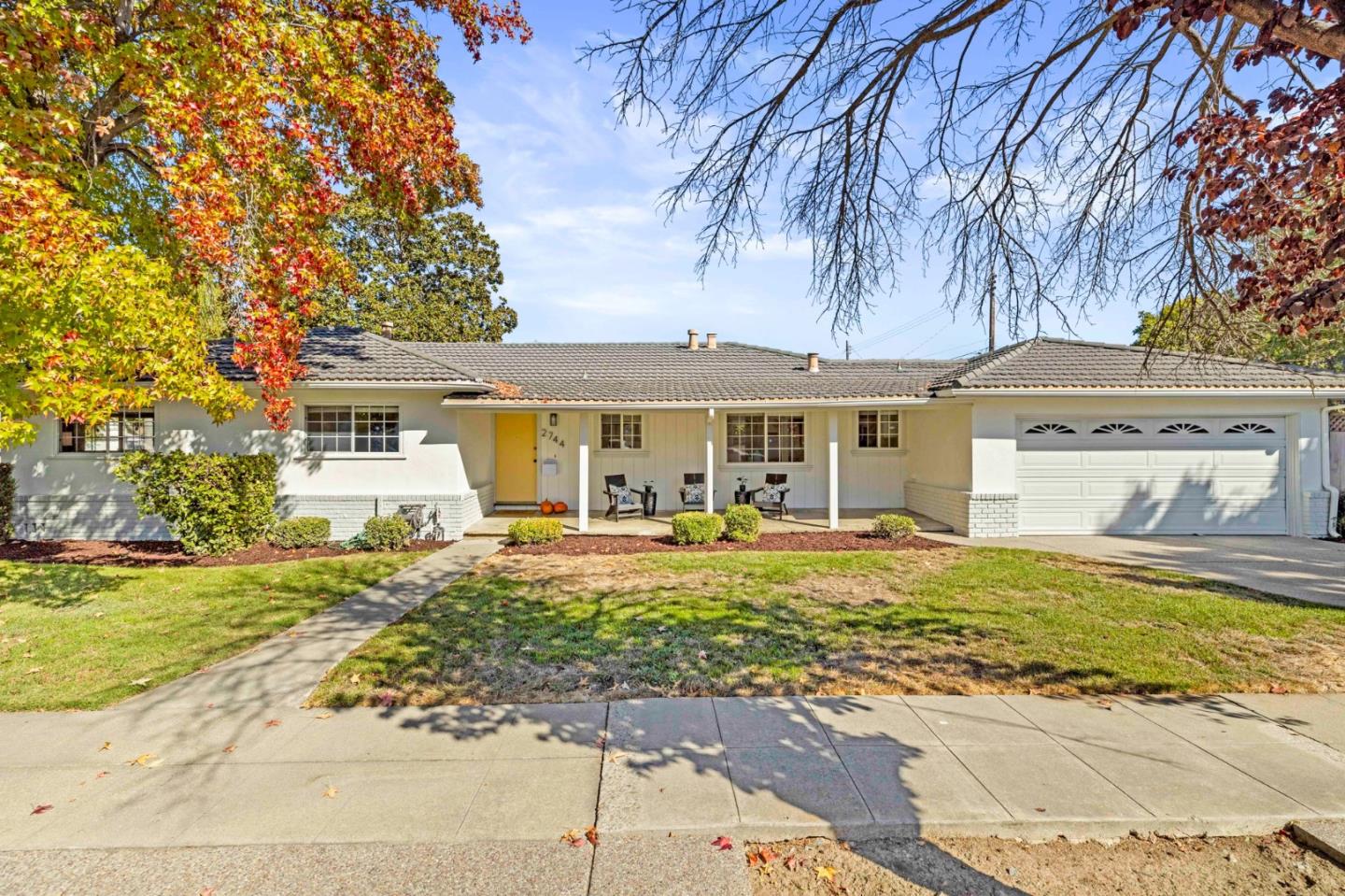 a front view of a house with a garden and patio