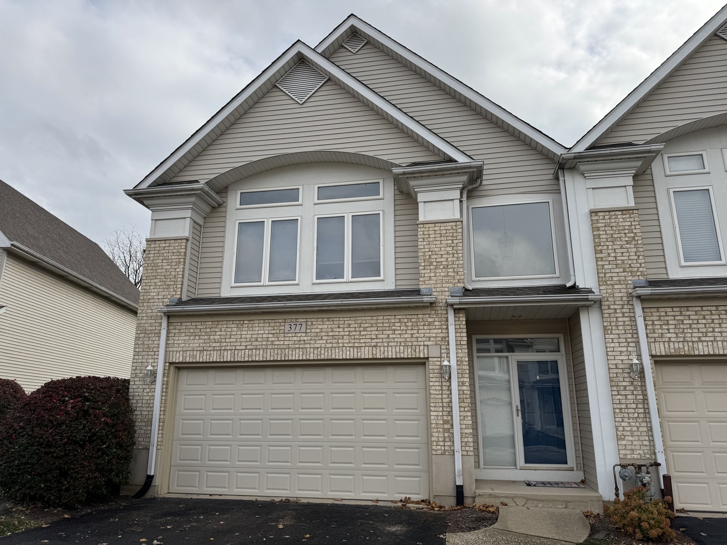 a front view of a house with a garage